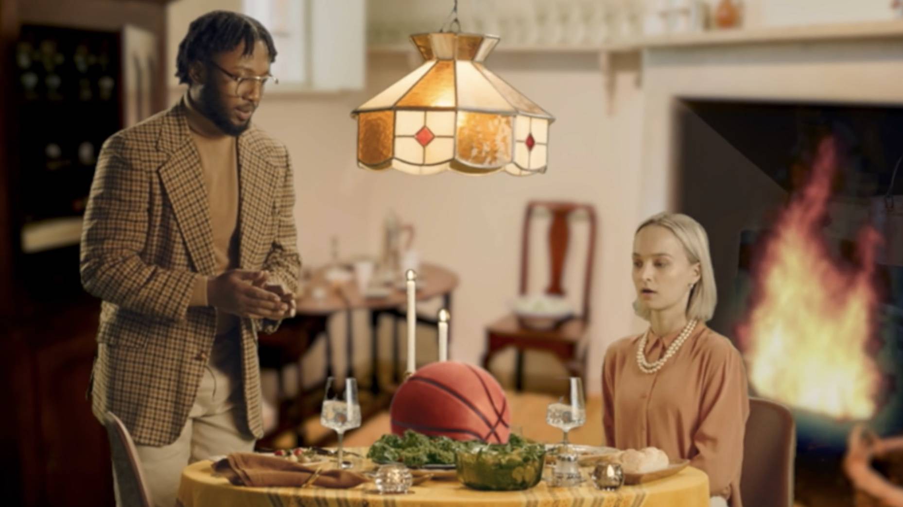 Couple at the dinner table with a basketball as the main dish