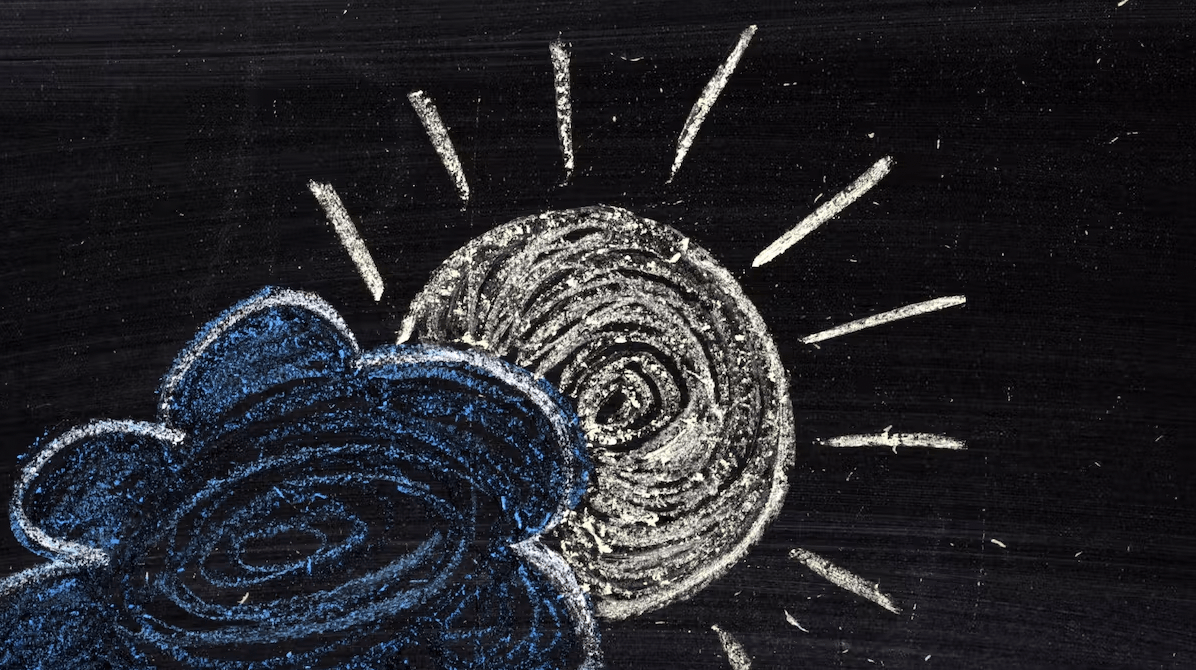 Chalk board image of a sun coming out from behind a cloud.