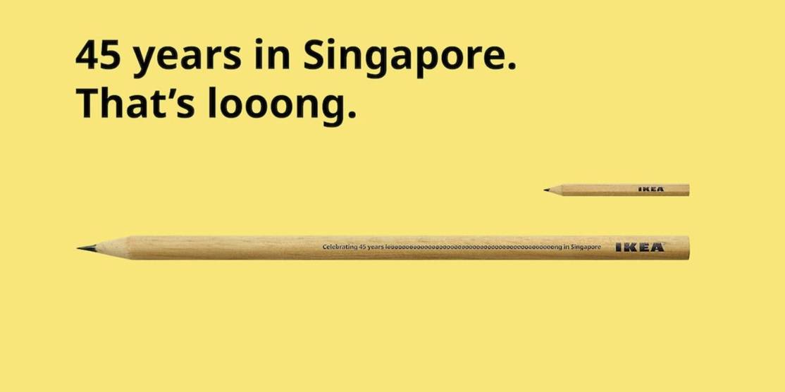 Over a yellow background are two pencils – one normal sized and one really long. Above the pencils in black text reads "45 years in Singapore. That's looong."